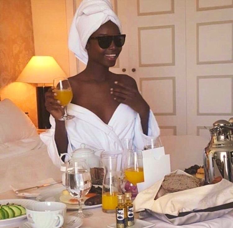 Black woman enjoying room service