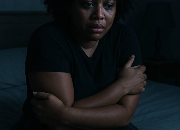 Woman scared hugging herself
